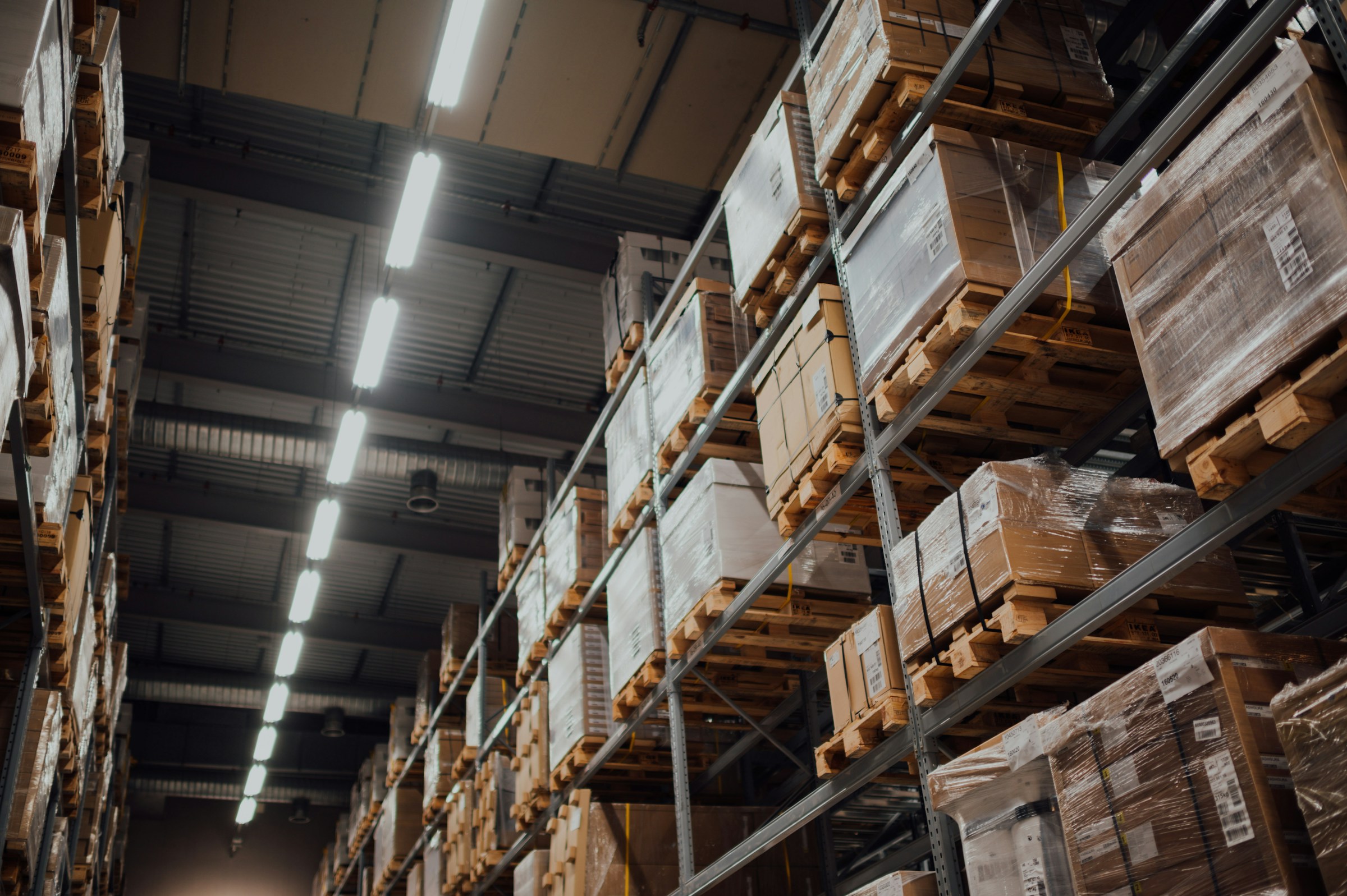 High-bay warehouse racking stacked with cartons of imported goods ready for distribution