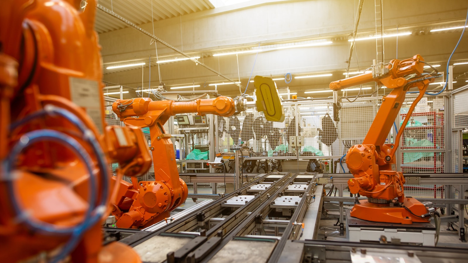 Robotic arms working on an automated assembly line inside a manufacturing plant