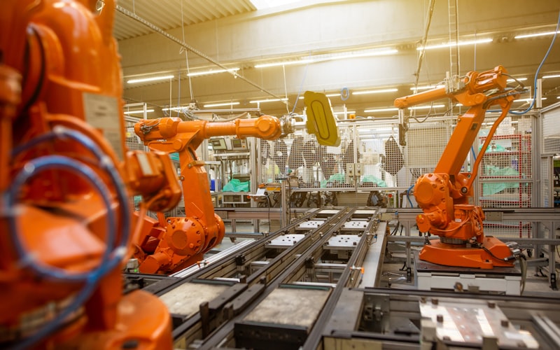 Robotic arms working on an automated assembly line inside a manufacturing plant