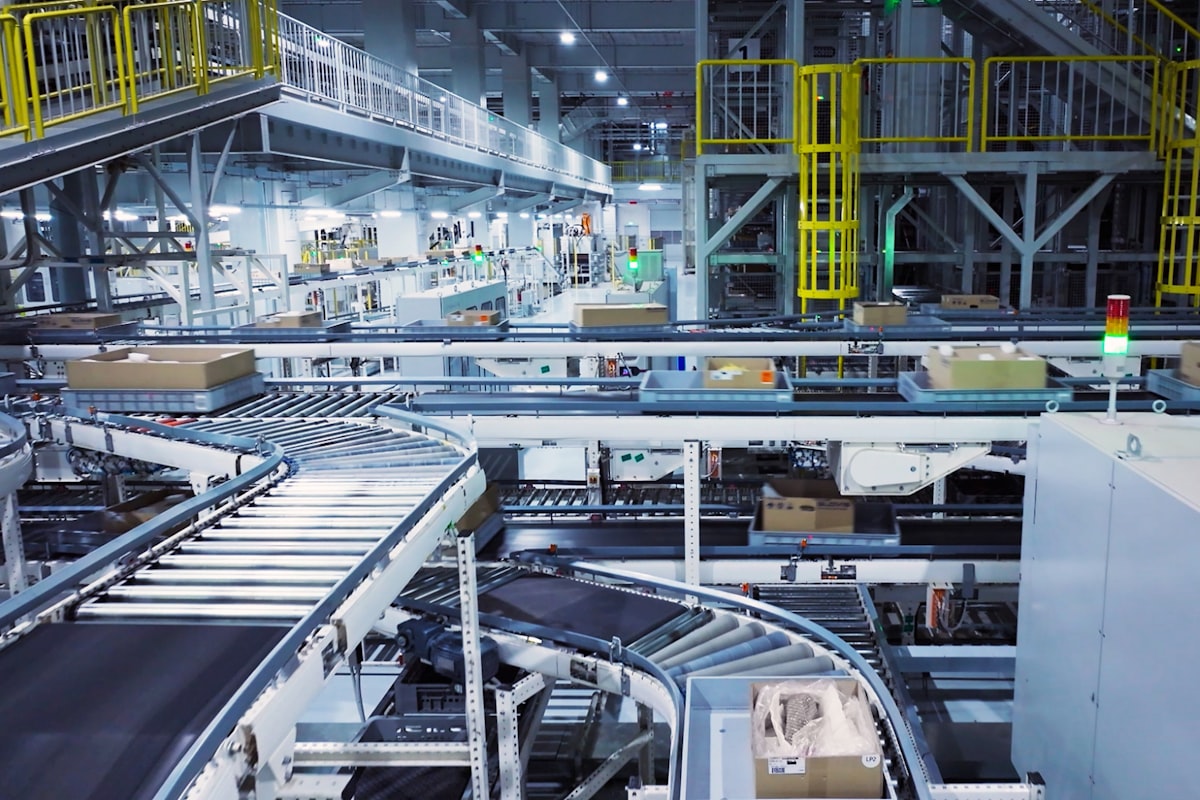 Cartons moving along a conveyor in a factory packing and consolidation area